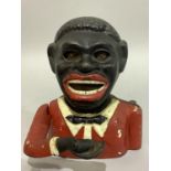 A cast iron money box in the form of a black man