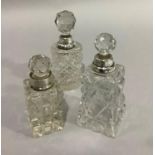 Three cut glass silver mounted perfume bottles with faceted stoppers, London 1906 and 1907 and
