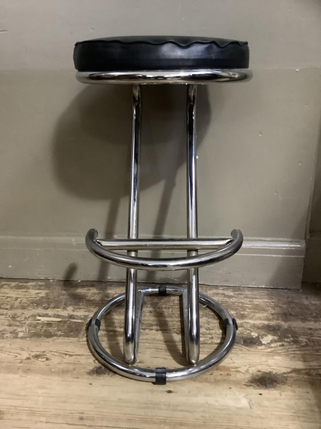 A black leatherette and tubular chrome cantilever stool