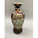 A late 19th/early 20th century Imari vase painted in typical pallet with reserves of garden