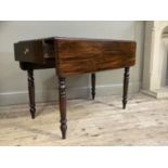 A 19th century mahogany Pembroke table with apron drawer to one end and on turned legs
