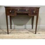 A mahogany bow fronted side table having a door to the centre over a kneehole flanked by a deep