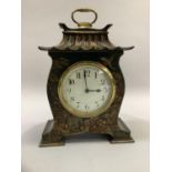 Early 20th century black and gilt chinoiserie mantel clock of pagoda shape with gilt bass carrying