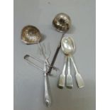 A collection of silver cutlery including three 19th century teaspoons, silver handled meat fork