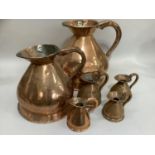 A matched set of six copper measures including two gallons and one gallon with Victoria marks,
