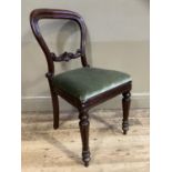 A Victorian mahogany dining chair with foliate carved tie rail, upholstered seat and on turned legs