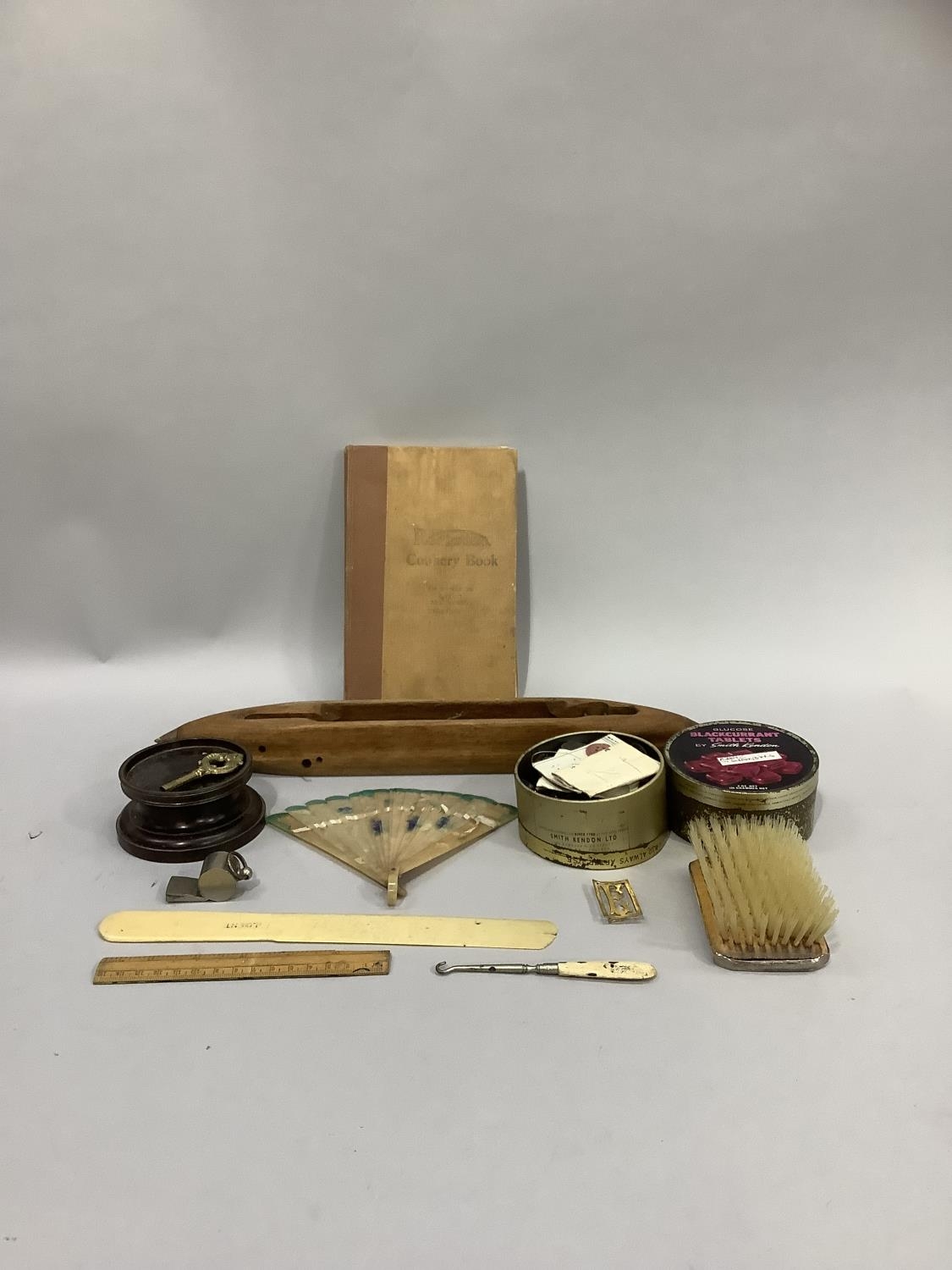 A gentleman's sterling silver backed hairbrush, vintage buttons, celluloid fan, shuttle, turned