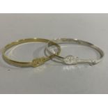 Two bangles 'Elvis' pierced within a guitar outline white metal and gilt metal (tests on silver