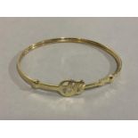 A bangle in 9ct gold, Elvis pierced within a guitar outline in presentation box, approximate