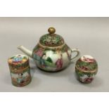 A miniature Chinese famille rose teapot painted with figures on a terrace and opposing reserve of