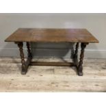 An oak refectory occasional table on turned standards joined by a stretcher