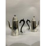 A pair of Queen Anne style silver plated cafe au lait pots with ebonised scroll handles, 21.5cm