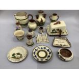 A collection of Torquay ware, earthenware with white slip painted in greens and inscribed with