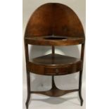 A early 19th century mahogany corner washstand with panelled back