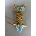 A Scandinavian silver gilt owl brooch set with pale blue champleve tail feather and green chalcedony