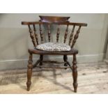 A 19th century elm capstan chair with spindle back and turned legs