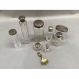 A collection of late 19th and early 20th century silver lidded toilet jars and bottles together with