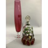A Cranberry glass vase by Dartington and a small liqueur bottle.
