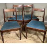 A set of four early 19th century mahogany dining chairs with ebony stringing to the bar back above a