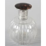 A CUT GLASS GLOBULAR SCENT BOTTLE with reeded fluting with silver collar and hinged tortoiseshell