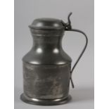 A LIDDED PEWTER FLAGON OF WAISTED FORM, the domed lid with thumb piece and a strap handle, the