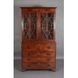 A GEORGE IV FIGURED MAHOGANY SECRETAIRE-BOOKCASE having a moulded cornice above two tracery glazed