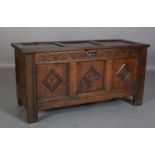 AN 18TH CENTURY OAK JOINED CHEST, having a triple indented top, demi-lune carved frieze over a