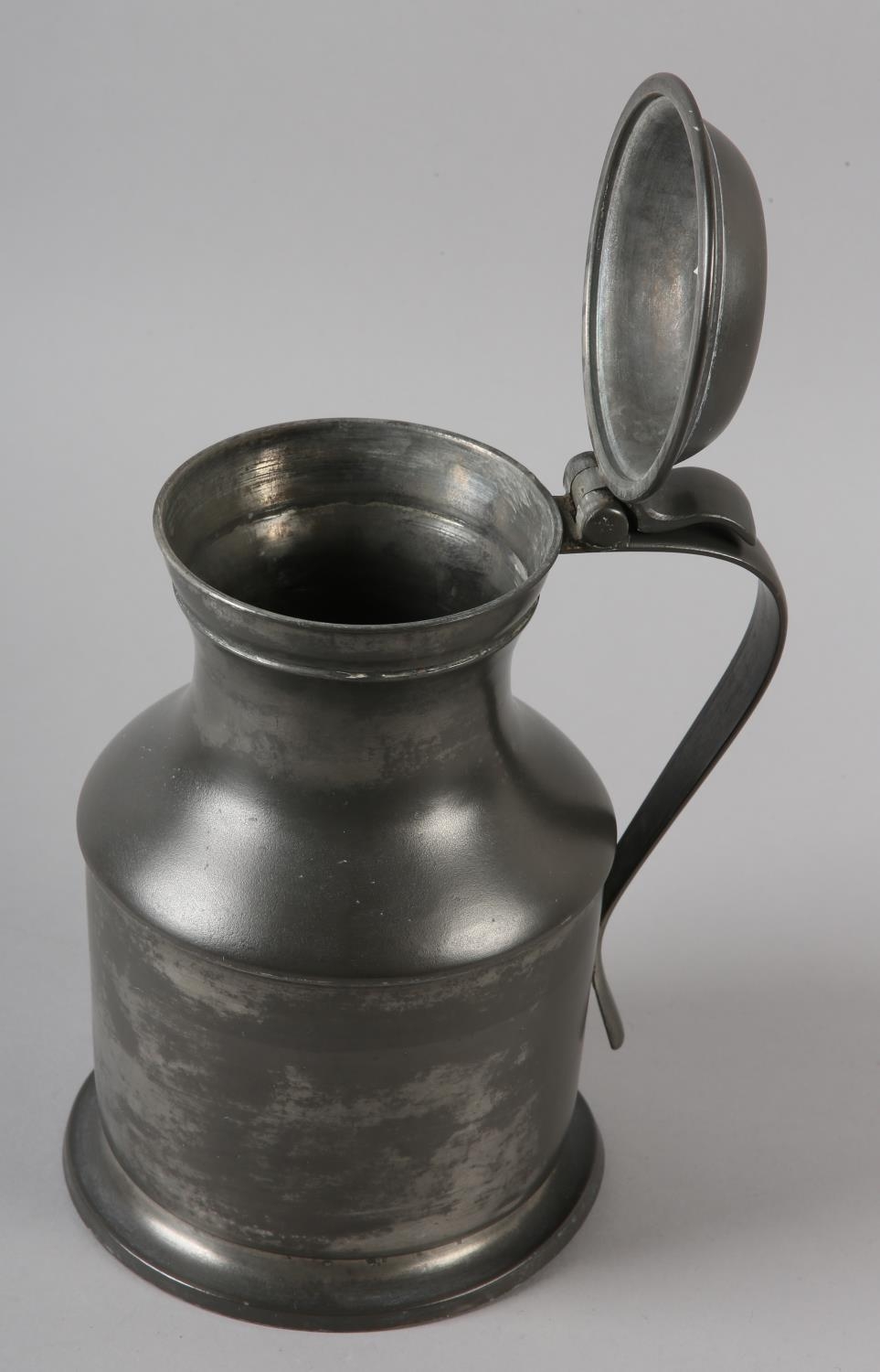 A LIDDED PEWTER FLAGON OF WAISTED FORM, the domed lid with thumb piece and a strap handle, the - Image 2 of 3