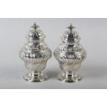 A PAIR OF GEORGE III SILVER CADDIES, Alexander Johnson, London 1757, of writhen baluster vase form