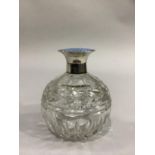 A GLOBULAR CUT GLASS SCENT BOTTLE with reeded fluting, silver collar and blue enamel hinged top,