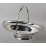 A LATE 18TH CENTURY SILVER CAKE BASKET, Joseph Scammel, London 1794, oval, reeded swing handle,