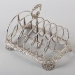 A GEORGE IV SILVER TOAST RACK, Joseph Angel, London 1824, seven bar with foliate and 'C' scroll loop