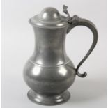 A LARGE PEWTER LIDDED SERVING JUG FOR BEER, of baluster form, the lid with acanthus thumb piece, 'S'