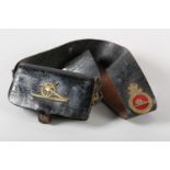 AN EARLY 20TH CENTURY ROYAL ARTILLERY SHOULDER BELT with officer pouch all in black leather, the