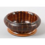 A LATE 19TH CENTURY TURNED WALNUT BOWL, inlaid in boxwood and ebony vertical banding, the well inset