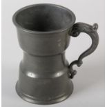 AN UNUSUAL PEWTER TANKARD waisted form, leaf capped scroll handle, marked to the rim with LONDON,