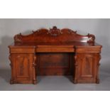 A VICTORIAN FIGURED MAHOGANY PEDESTAL SIDEBOARD having a raised back of arched profile with