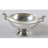 AN EDWARD VII SILVER TWO HANDLED PEDESTAL BOWL, London 1909, circular with bead and reel rim,