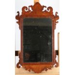 AN 18TH CENTURY MAHOGANY VENEERED WALL MIRROR of 18th century style fret cut frame with arched