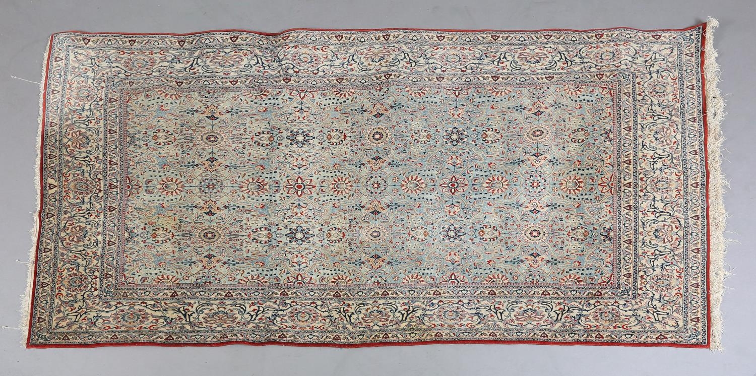 A MIDDLE EASTERN CARPET, the duck egg blue field with all-over plant forms in red, ivory,