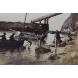 FRANK MEADOW SUTCLIFFE (1853-1941), Young boys in bathing shorts helping to unload fishing boats