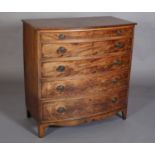 AN EARLY 19TH CENTURY FIGURED MAHOGANY BOW FRONT CHEST having a shallow drawer above four