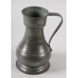 A PEWTER SERVING JUG of baluster form, strap handle, marked to the rim with maker, date and assay
