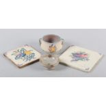 TWO CARTER POTTERY TILES, c.1920s, white earthenware and slip each painted with ribbon-tied flower