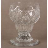 A BONNET OR MONTEITH GLASS with honeycomb moulded double ogee bowl, a ribbed collar stem and a plain