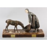 AN ART DECO PAINTED METAL AND IVORINE FIGURE GROUP of a country girl feeding a donkey, on marble