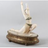 AN ART DECO ALABASTER FIGURE OF AN EASTERN DANCER, wearing a turban headdress and costume, raised on