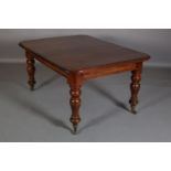 A VICTORIAN MAHOGANY EXTENDING DINING TABLE, with two leaves, on baluster turned legs with brass