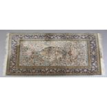 A PERSIAN SILK AND WOOL CARPET, the pale blue field with central medallion birds and flowering