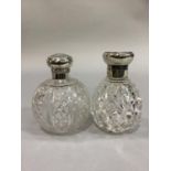 TWO GLOBULAR DIAMOND CUT GLASS SCENT BOTTLES with silver collars and hinged tops, London 1906 and